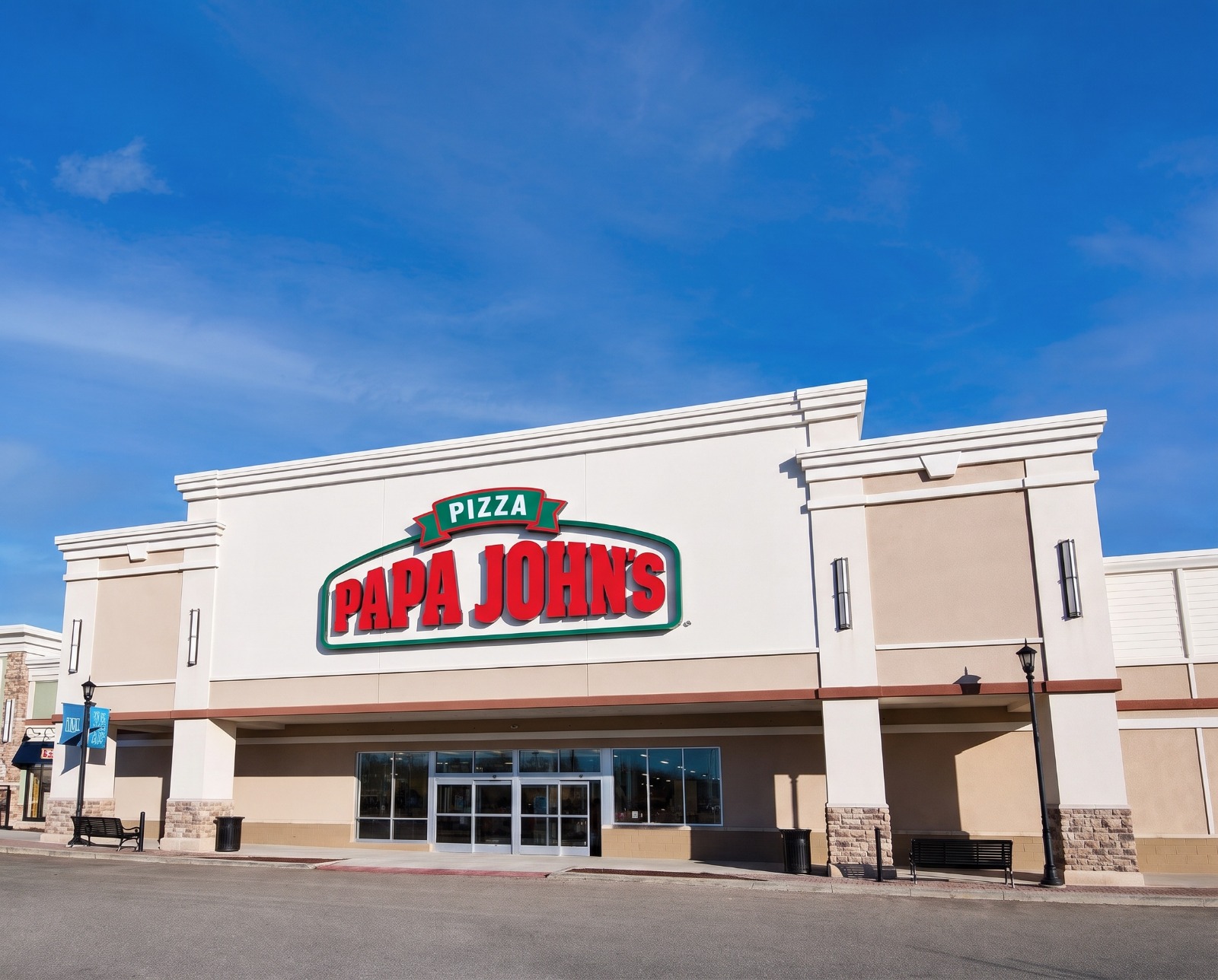 The same storefront with the proposed sign installed